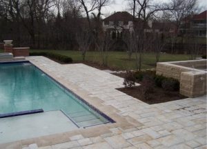 large stone walkways around a swimming pool