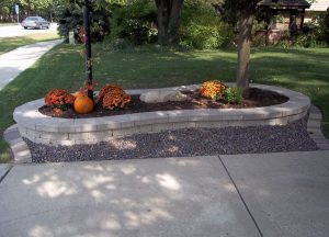 stone flower bed with orange flowers