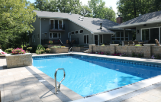 Pool area with paver patio, retaining walls, and flower boxes